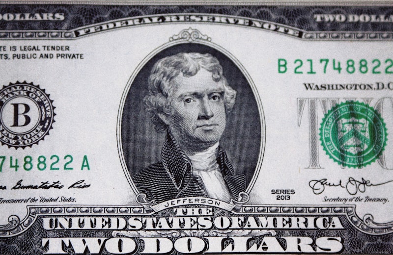A US dollar bill on display against a dark background, showing the type of specimen presentation used when evaluating collectible currency