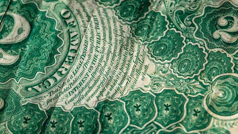 A crisp one dollar bill photographed from above showing the full note design, the same perspective used for professional currency photography and grading submissions